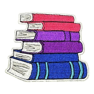 May include: A stack of embroidered books in shades of pink, purple, and blue. The books are stacked on top of each other and have a white outline.