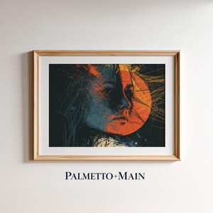 May include: A framed art print featuring a stylized portrait of a person with long hair, rendered in shades of blue, black, and orange. A large orange circle sits behind the face, with thin, radiating lines extending outward. The text PALMETTO+MAIN appears below.