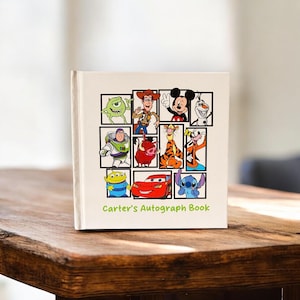 May include: A cream-colored autograph book featuring cartoon characters in black frames. The cover displays characters like Mickey Mouse, Buzz Lightyear, and Lightning McQueen. The text "Carter's Autograph Book" is printed at the bottom in green.