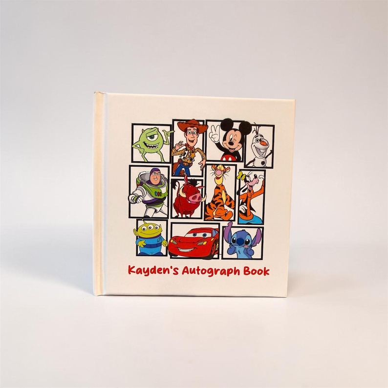May include: A cream-colored autograph book featuring a collage of Disney characters in black-framed squares. Characters include Mike Wazowski, Woody, Mickey Mouse, Buzz Lightyear, Pumbaa, and Stitch. The text "Kayden's Autograph Book" is printed in red.