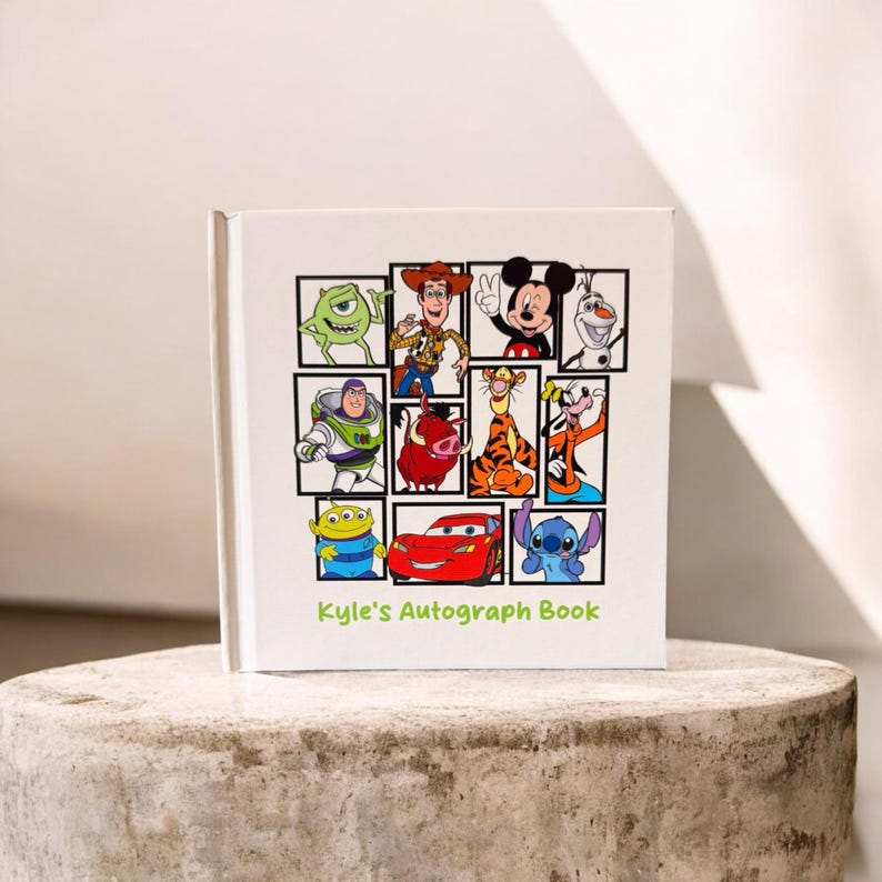 May include: White autograph book featuring cartoon characters like Mickey Mouse, Buzz Lightyear, and Stitch. The cover has a grid of character images and the text "Kyle's Autograph Book" in green.
