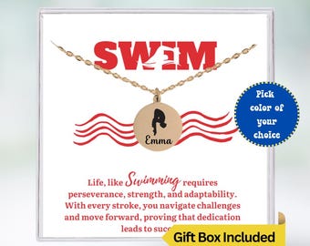 May include: Gold necklace with a swimmer pendant and the word "SWIM" in red letters. The pendant has the name "Emma" engraved on it. The necklace comes in a gift box.  "Life, like Swimming requires perseverance, strength, and adaptability. With every stroke, you navigate challenges and move forward, proving that dedication leads to success."