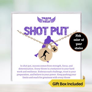 May include: Gold necklace with a shot put charm and a letter charm. The necklace comes in a gift box. The text on the card reads "Track and Field Shot Put".