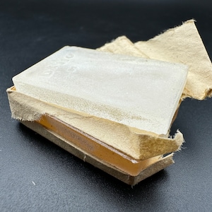 May include: Two clear glass squares in a brown paper box. The glass squares are slightly frosted and have a textured surface.