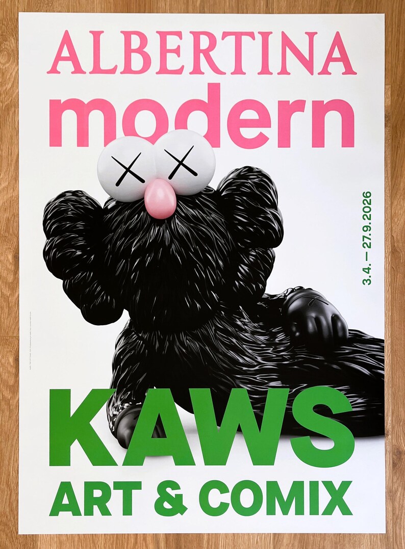May include: Poster with a black KAWS figure, white eyes with crosses, and a pink nose. The poster reads "ALBERTINA modern" in pink and "KAWS ART & COMIX" in green. The date "3.4. - 27.9.2026" is also displayed.