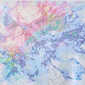 May include: A close-up of a colorful diamond painting depicting a floral design with pink, blue, and green hues. The painting is made up of small, square beads that create a mosaic effect.