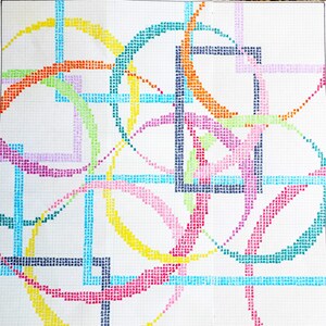 May include: Abstract geometric design created with colored pencil on graph paper. The design features overlapping circles and squares in shades of blue, green, yellow, pink, orange, and purple.