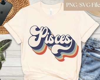 May include: A white t-shirt with a retro-style graphic of the word "Pisces" in blue, red, orange, and yellow.