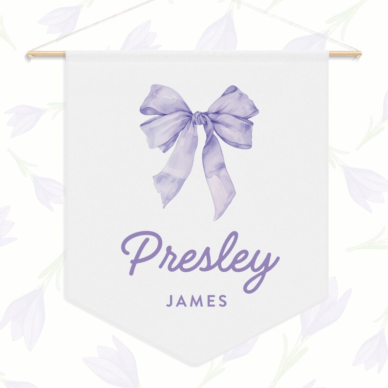 May include: A white banner with a purple bow and the name "Presley James" written in purple script.