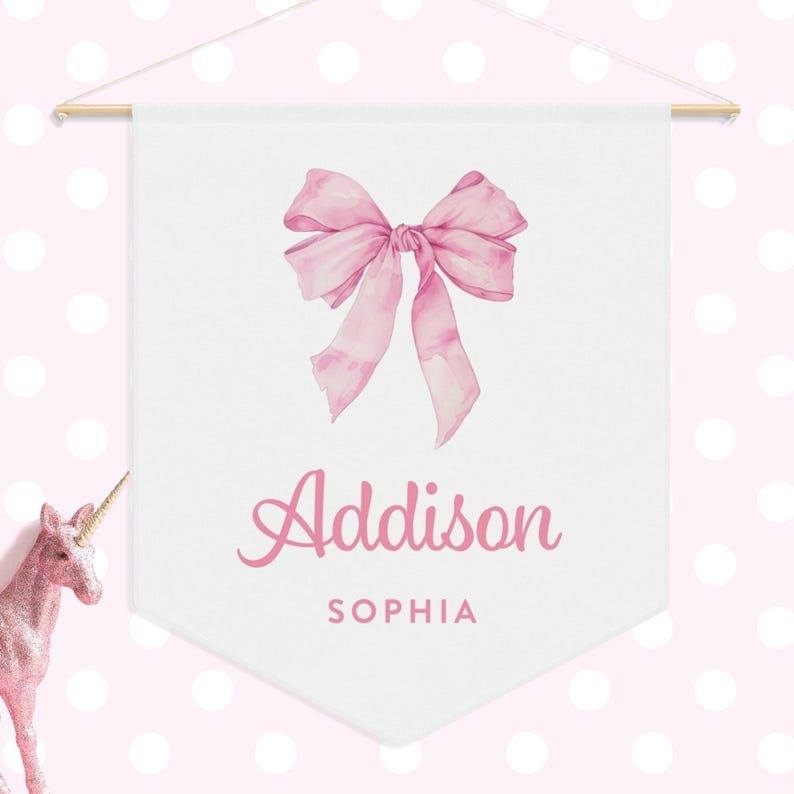 May include: A white banner with a pink watercolor bow and the text "Addison Sophia" in pink script.