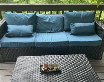 Six-piece patio furniture set with waterproof covers and peacock blue anti-slip cushions