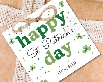 May include: A white gift tag with green shamrocks and the text "happy St. Patrick's day" in green and white lettering. The tag also includes the text "FROM ELLIE" in black lettering.