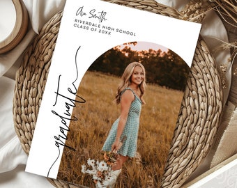 May include: Graduation announcement with a white background and black text. The text reads "Ann Smith, Riverdale High School, Class of 20XX". The announcement features a photo of a young woman in a blue and white dress standing in a field. The text "graduate" is written in cursive in the lower left corner of the announcement.