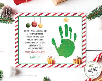 May include: A Christmas card with a green handprint shaped like a Christmas tree with red and gold ornaments. The card reads "This isn't just a Christmas tree as you can plainly see I made it with my hand which is a part of me It comes with lots of love especially to say I hope you have a very Merry Christmas Day! Aubrey"