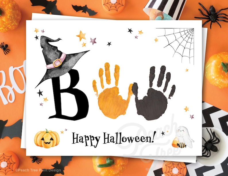 May include: A white card with a black witch hat, the letter "B", two handprints, one orange and one black, and the text "Happy Halloween!"