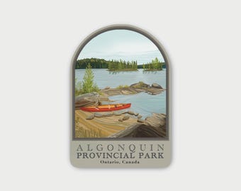 May include: A rectangular sticker with an arched top featuring a landscape illustration of a red canoe on a sandy shore by a lake. The scene includes rocky outcrops, pine trees, and water. The text reads ALGONQUIN PROVINCIAL PARK Ontario, Canada.