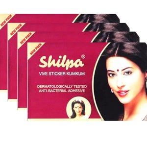 May include: Four stacked rectangular maroon product packages of Shilpa Vive Sticker Kumkum. Each package features the brand name, text stating dermatologically tested anti-bacterial adhesive, and a portrait of a person wearing a bindi.