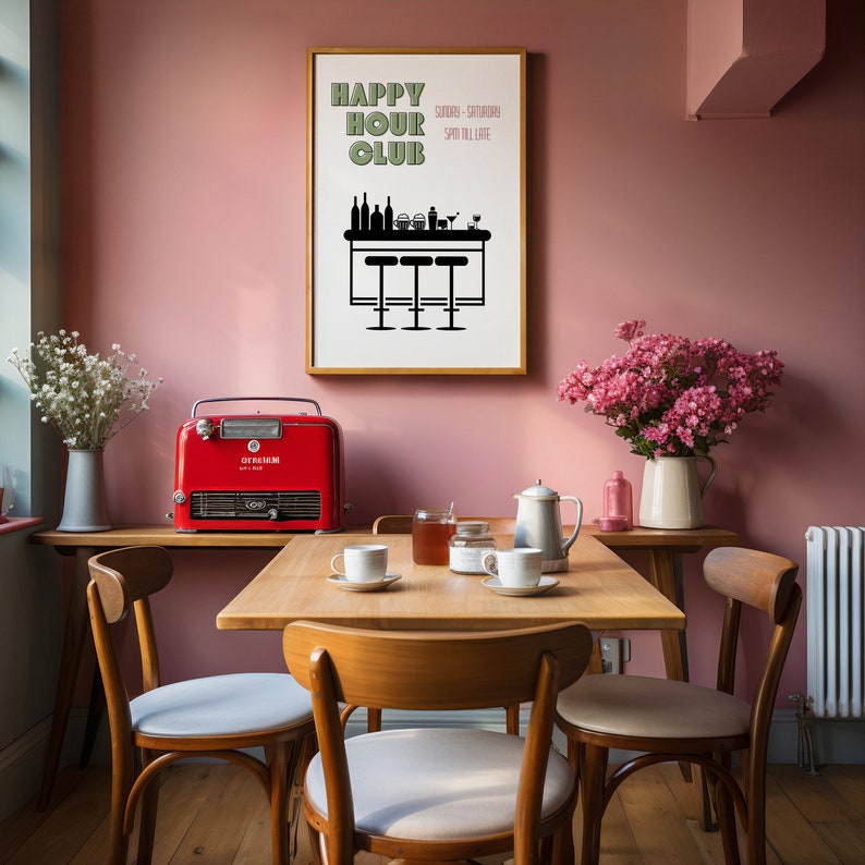 May include: A red and black vintage-style electric heater sits on a wooden table in a dining room. The table is set with four chairs, a teapot, and four cups and saucers. A framed poster with the text "Happy Hour Club" hangs on a pink wall.