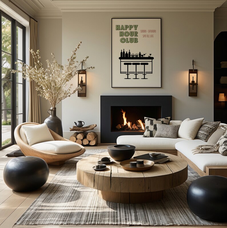 May include: A living room with a fireplace, a white sectional sofa, a round wooden coffee table, a black bowl, a black and white rug, and a framed poster that says "Happy Hour Club".