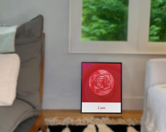 May include: A red and white watercolor print with a symbol in the center and the text "I am" at the bottom. The symbol is a red circle with a white triangle inside and a white circle around it. The print is framed in a black frame.