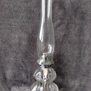 Vintage oil lamp Tall and clear glass. very clean. New Wick in it.