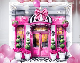 May include: A pink and white storefront with a pink bow and the words "Cafe" and "Angelica" above the entrance. The storefront has two windows and a door with glass panels. There are pink flowers and green bushes in front of the storefront.