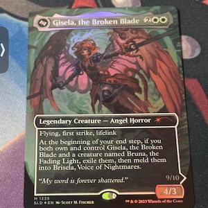 May include: A Magic: The Gathering card featuring Gisela, the Broken Blade. The card depicts a winged figure with a sword, in shades of red, brown, and black. Text includes "Legendary Creature - Angel Horror" and a quote. The card is numbered 9/10 and 4/3.