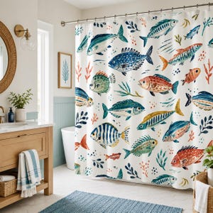 May include: A white shower curtain featuring a repeating pattern of various fish in shades of blue, orange, and green, interspersed with small aquatic plant illustrations. The curtain hangs from a metal rod with rings in a bathroom setting.