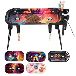 May include: A black rolling tray table with a colorful psychedelic design. The table has four legs and a tray with a built-in grinder and storage compartments. The tray is removable and comes in several different designs.