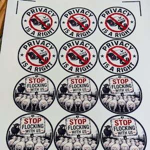 May include: A sheet of twelve circular stickers featuring two designs. Six stickers show a security camera with a red prohibition symbol and the text PRIVACY IS A RIGHT. Six stickers show a flock of sheep and the text STOP FLOCKING WITH US.