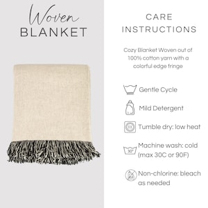 May include: A woven blanket made of 100% cotton yarn in a light beige color with a dark, multi-colored edge fringe. The image includes text: Woven Blanket, Care Instructions, Cozy Blanket Woven out of 100% cotton yarn with a colorful edge fringe, Gentle Cycle, Mild Detergent, Tumble dry: low heat, Machine wash: cold (max 30C or 90F), Non-chlorine: bleach as needed.