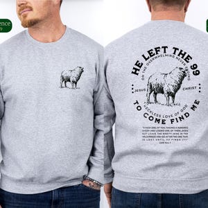 May include: Gray sweatshirt with a black graphic print of a sheep and the text "He Left The 99... To Come Find Me". The text includes a quote from the Bible, Luke 15:3-7.