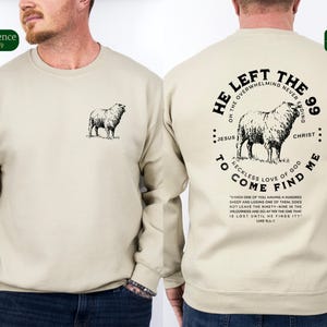 May include: A beige sweatshirt with a black sheep graphic on the front and a black graphic on the back that says "He Left The 99 Of The Overwhelming Never Ending Jesus Christ To Come Find Me Reckless Love Of God" with a quote from Luke 15:3-7.