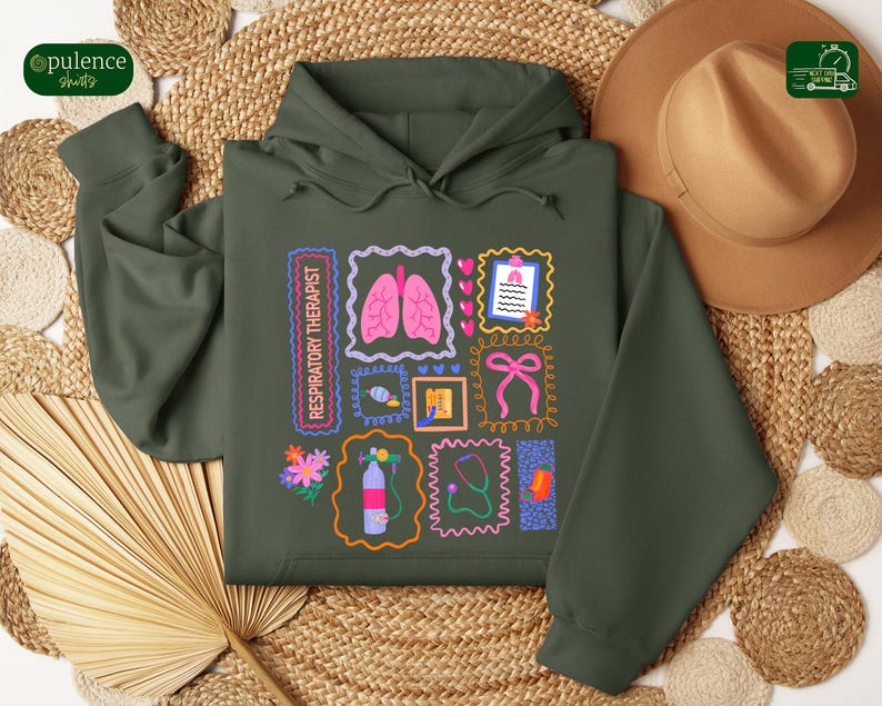May include: Dark green hoodie with a colorful graphic design featuring medical-themed illustrations. The design includes images of lungs, a stethoscope, and a bow, with the text "RESPIRATORY THERAPIST".