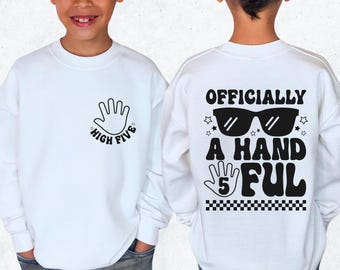May include: White sweatshirt with a black handprint and the text "High Five" on the front and the text "Officially a Handful 5" with sunglasses and stars on the back.