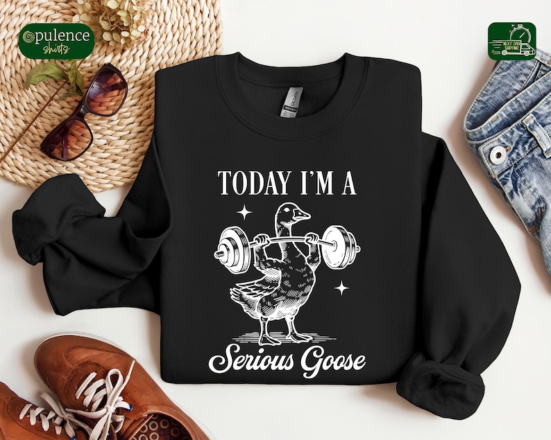 May include: Black sweatshirt with a white graphic of a goose lifting weights. The text "Today I'm a Serious Goose" is printed below the image.