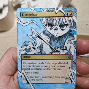 May include: Customized "Electrolyze" Magic: The Gathering card featuring a blue and white anime-style character with lightning effects. The card has the text "Electrolyze" and "Instant".
