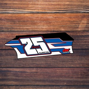 May include: A white racing number plate with the number 25 in bold black lettering and the name "CLANTON" in smaller black lettering. The plate has a blue, white, and black design with red accents. The plate has the letters "GW" in white with a red outline.