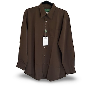 May include: A solid dark brown long-sleeve button-down shirt with a pointed collar and a single chest pocket. A white rectangular tag with black text is attached to the front placket by a string, featuring a small green circular brand logo.