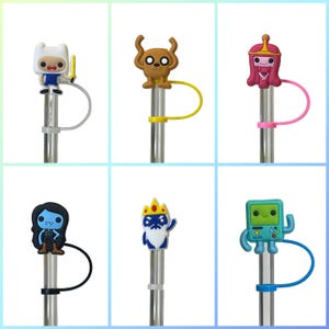 May include: Six colorful silicone straw toppers featuring characters from the animated television series Adventure Time. The toppers include Finn the Human, Jake the Dog, Princess Bubblegum, Marceline the Vampire Queen, Ice King, and BMO. Each topper has a matching silicone strap.