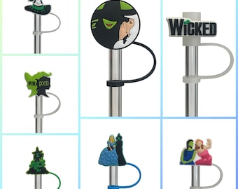 May include: Six different straw toppers featuring characters and designs from the musical Wicked. The toppers are made of plastic and have a loop for attaching to a straw. The designs include a witch's hat, a green face with a witch's hat, the word "Wicked", a green and black design with the words "For Good", a green Christmas tree, and two witches.