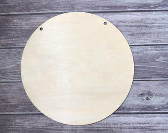 May include: A round, unfinished wooden sign with two pre-drilled holes at the top. The sign is made of light-colored wood and has a smooth surface. The sign is ready for painting or other customization. Perfect for home decor projects.