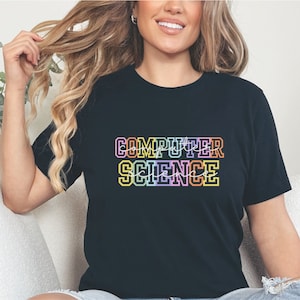 May include: A black t-shirt with the text "COMPUTER SCIENCE" in rainbow colors. The text is in a bold, blocky font.