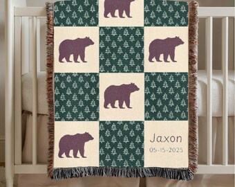 May include: A woven baby blanket with a repeating pattern of purple bears and green trees on a cream background. The blanket has a fringed edge and the name "Jaxon" and date "05-15-2025" are displayed.