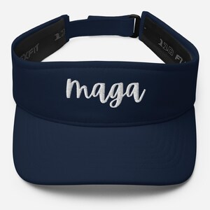 May include: A navy blue visor with a white embroidered "maga" text.
