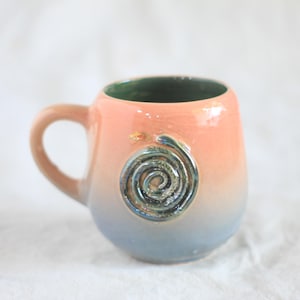 Tasse mit spiralförmiger Schlangenmotiv, Farbverlauf im Hintergrund, handgefertigt, mit Reliefs und schillernden Farben