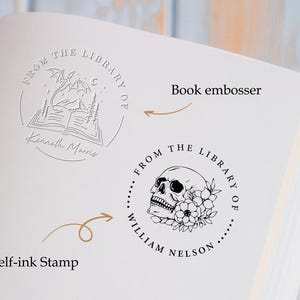 May include: Two self-inking stamps for book lovers. The first stamp features a dragon flying over an open book with the text "From the Library of Kenneth Morris". The second stamp features a skull with flowers and the text "From the Library of William Nelson".