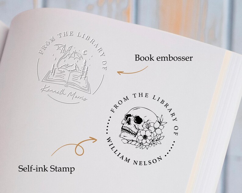 May include: Two self-inking stamps for book lovers. The first stamp features a dragon flying over an open book with the text "From the Library of Kenneth Morris". The second stamp features a skull with flowers and the text "From the Library of William Nelson".