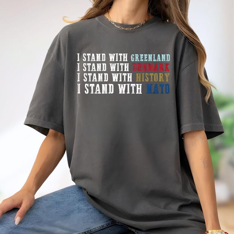 A person wearing a gray t-shirt with text printed on it.