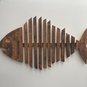 Large recycled timber wall piece in the style of a fish